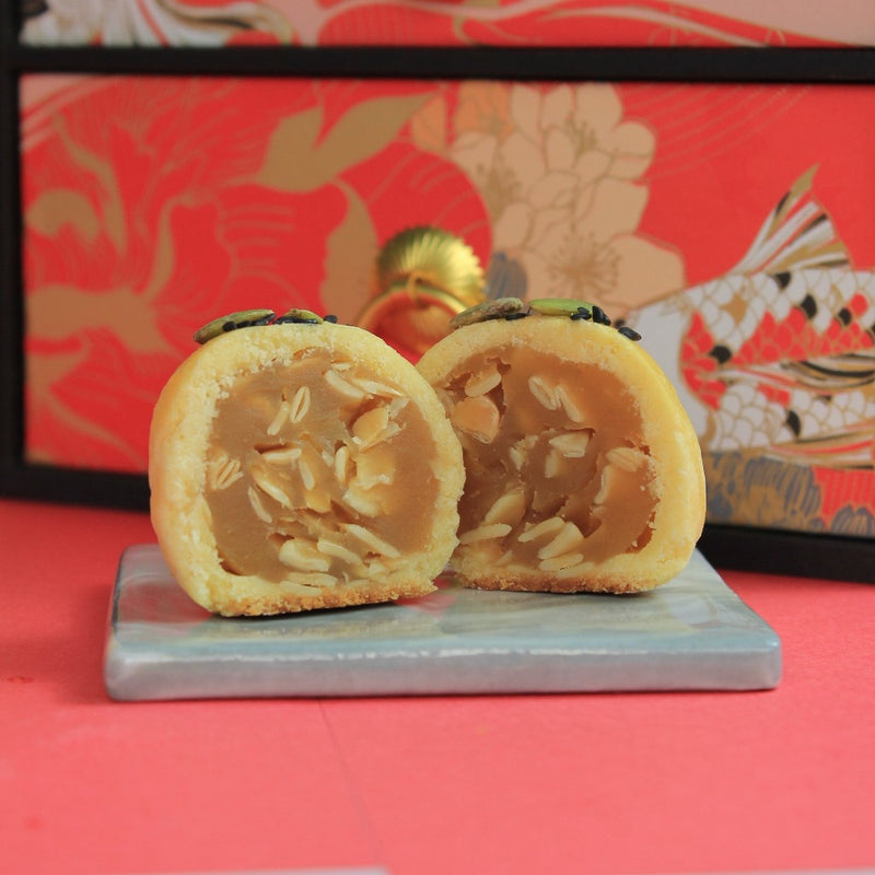 White Lotus paste filling with melon seeds. Topped with pumpkin seeds and sesame